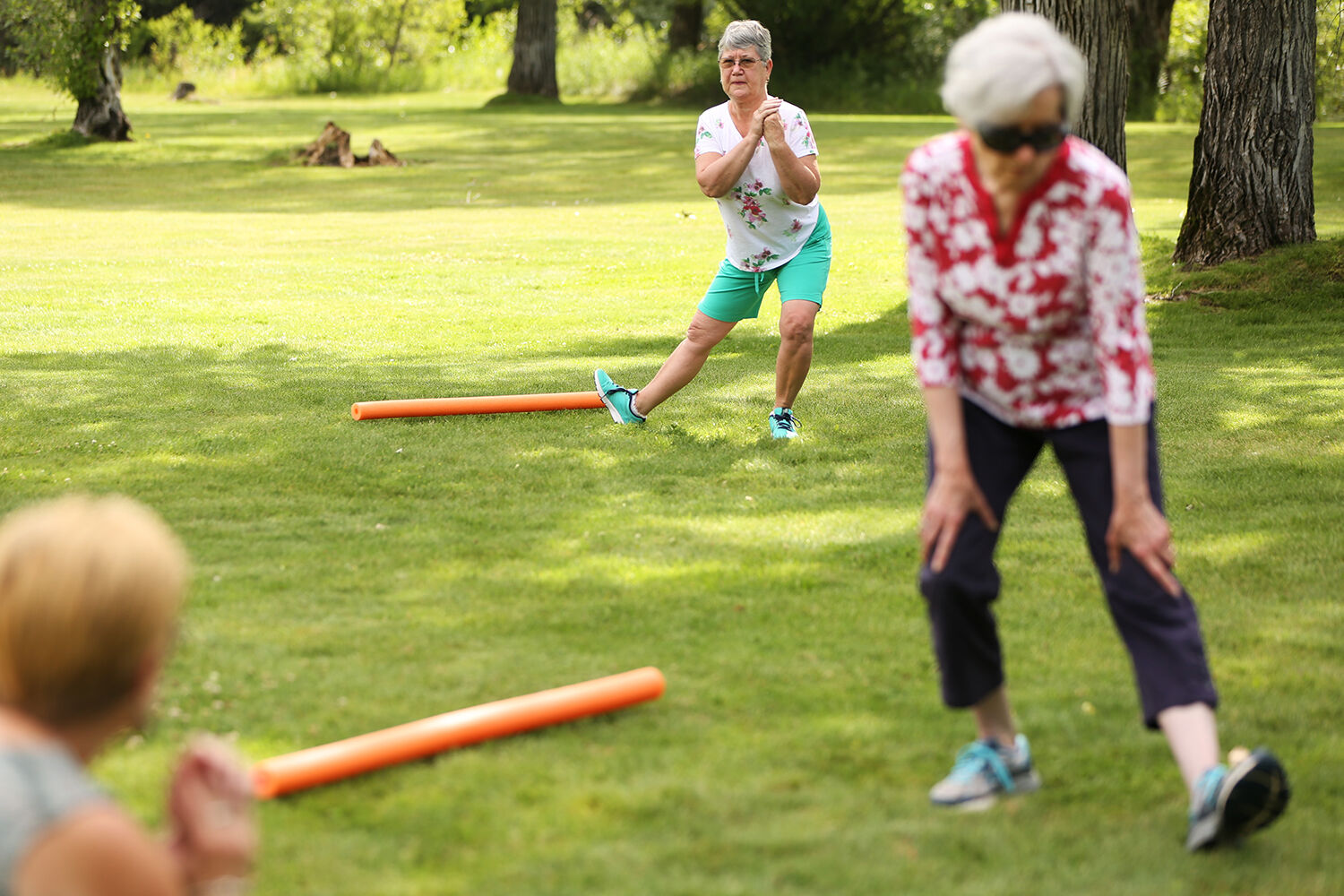 Sue Sydow, Myrna Baasch, and Carmen Christian stretch their calves